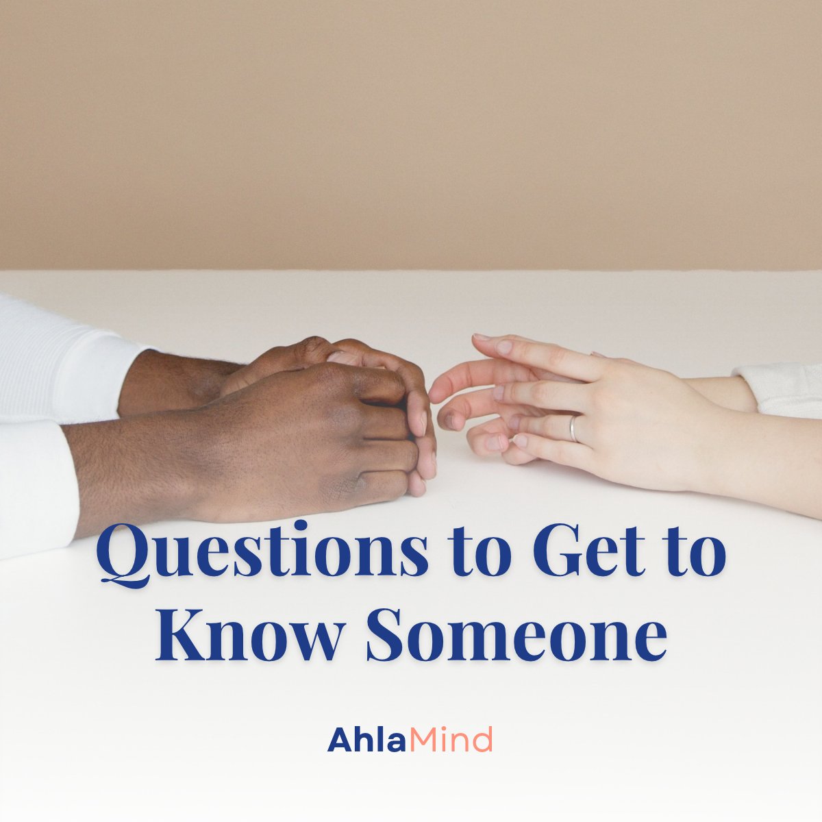 Two hands on a table reaching toward each other, symbolizing questions to get to know someone and real connection